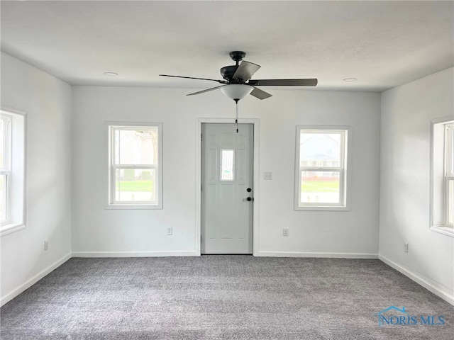 unfurnished room featuring light carpet and ceiling fan