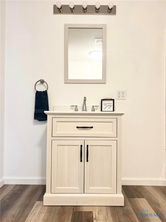 bathroom with hardwood / wood-style floors and vanity