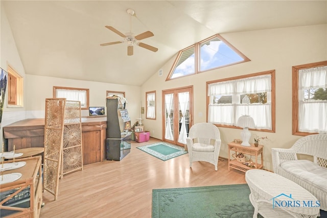 sunroom / solarium featuring french doors, vaulted ceiling, ceiling fan, and a healthy amount of sunlight