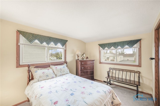 carpeted bedroom featuring a textured ceiling