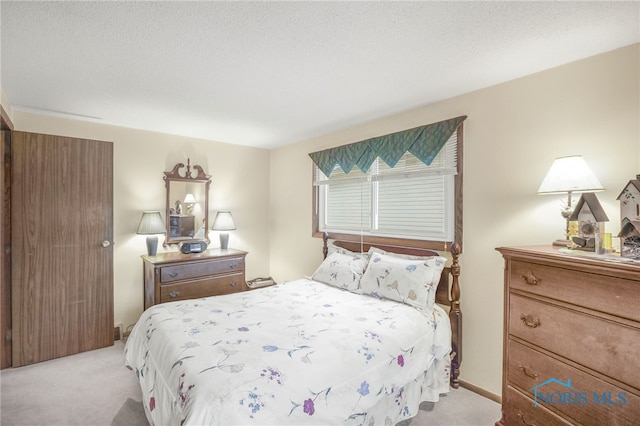 carpeted bedroom with a textured ceiling