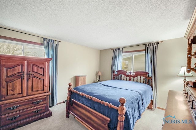 carpeted bedroom with a textured ceiling