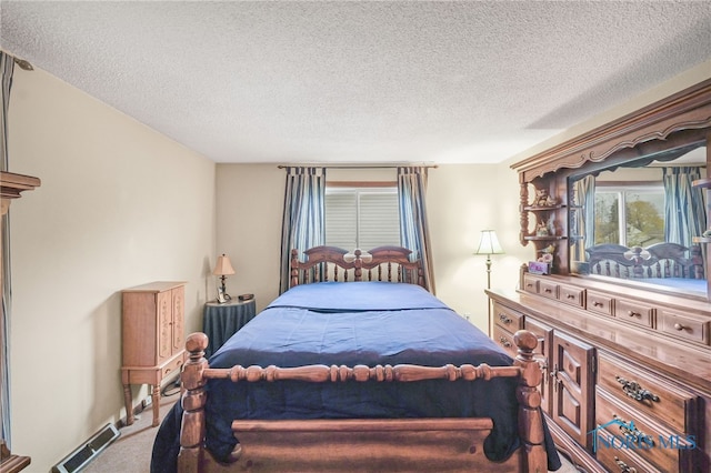 bedroom with carpet and a textured ceiling