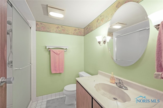 bathroom featuring tile patterned flooring, toilet, an enclosed shower, and vanity