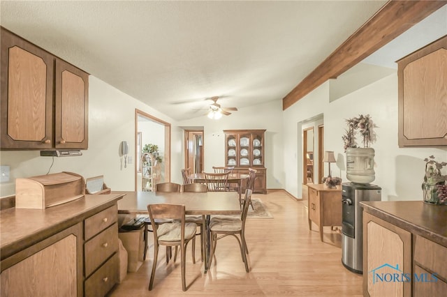 dining space with light hardwood / wood-style flooring, ceiling fan, and lofted ceiling