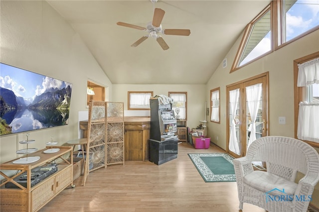 interior space featuring french doors, light hardwood / wood-style floors, high vaulted ceiling, and ceiling fan