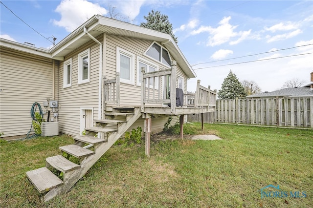 view of property exterior featuring a lawn and a deck