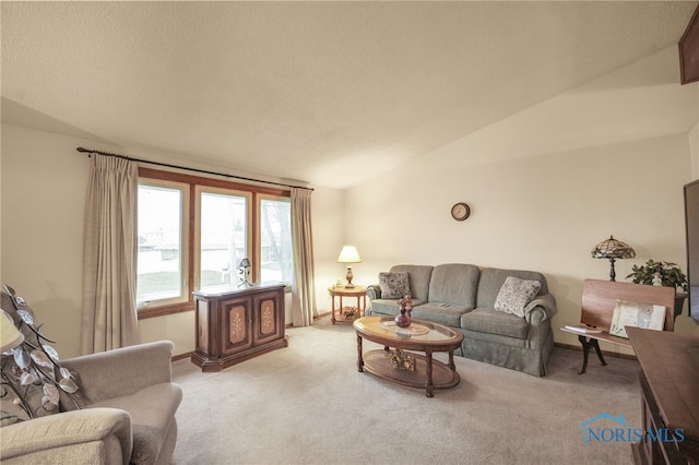 carpeted living room with a textured ceiling and vaulted ceiling