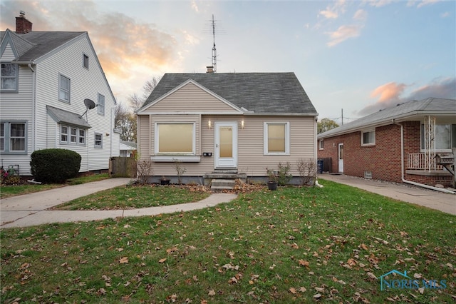 bungalow-style home with a yard