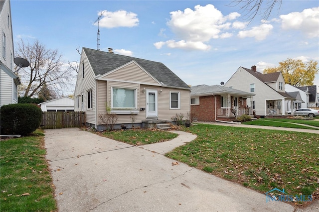 bungalow with a porch and a front yard