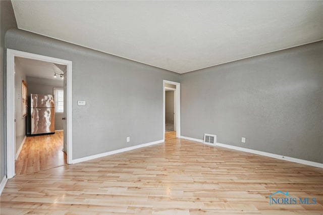 spare room with light wood-type flooring