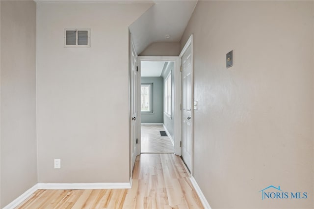 hall with light hardwood / wood-style floors