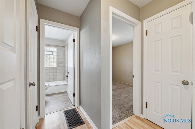 corridor featuring light hardwood / wood-style floors