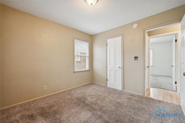 unfurnished bedroom featuring carpet and a closet