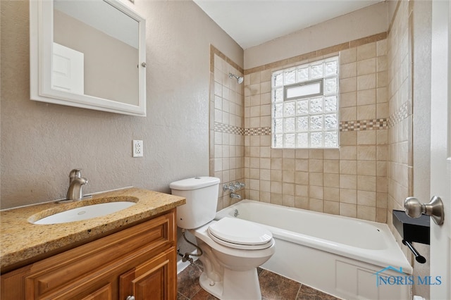 full bathroom featuring tile patterned floors, vanity, toilet, and tiled shower / bath