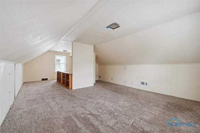 bonus room featuring lofted ceiling and carpet floors