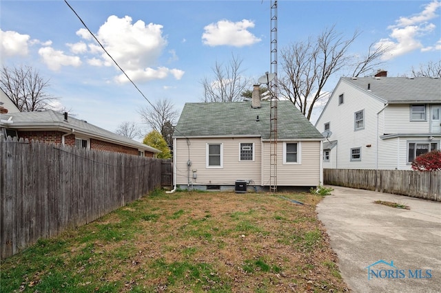 rear view of property with a yard and a patio