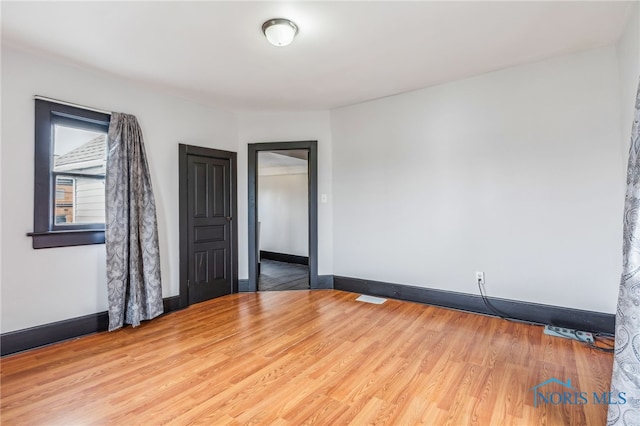 unfurnished room featuring hardwood / wood-style floors