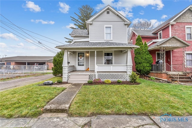 view of front of home featuring covered porch and a front yard