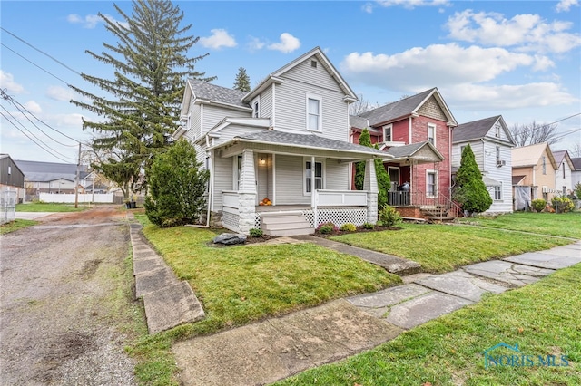 view of front of house with a porch and a front yard