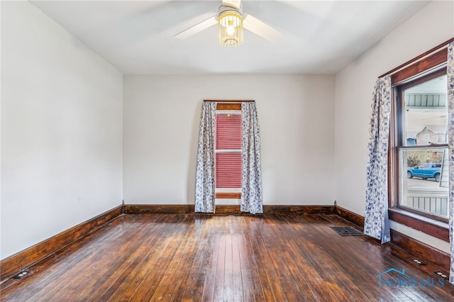 unfurnished room featuring dark hardwood / wood-style floors and ceiling fan