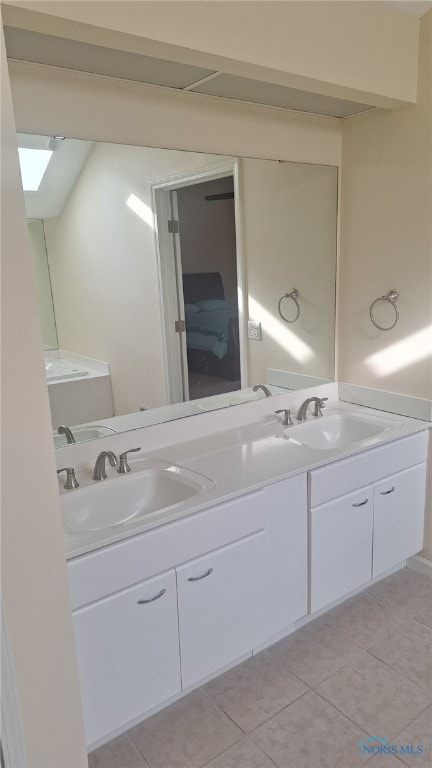 bathroom with tile patterned flooring and vanity