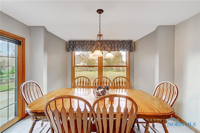 dining room featuring a notable chandelier and light tile patterned floors