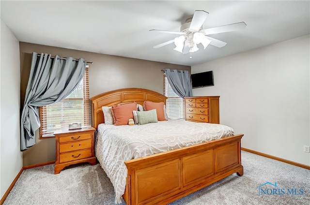 bedroom with ceiling fan and light colored carpet