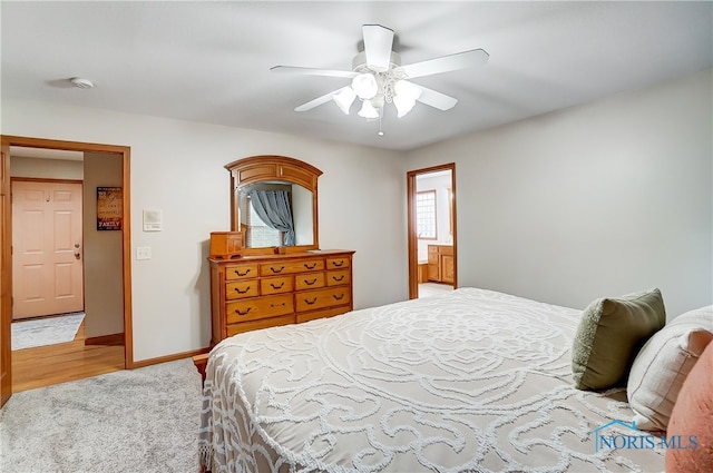 bedroom featuring ceiling fan, ensuite bathroom, and light hardwood / wood-style floors