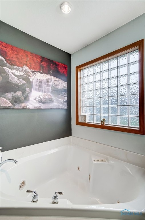 bathroom featuring plenty of natural light and a bathtub