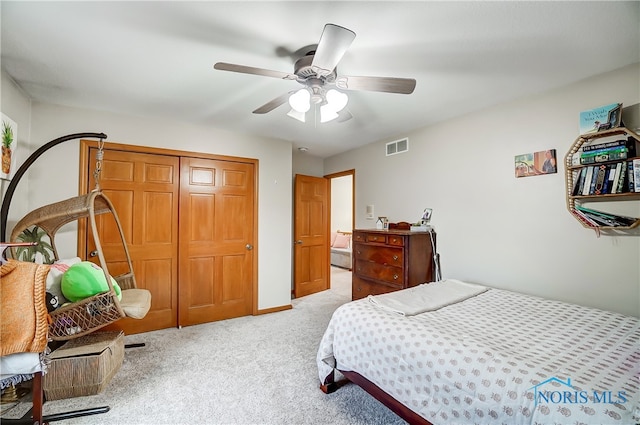 bedroom featuring ceiling fan, a closet, and light carpet