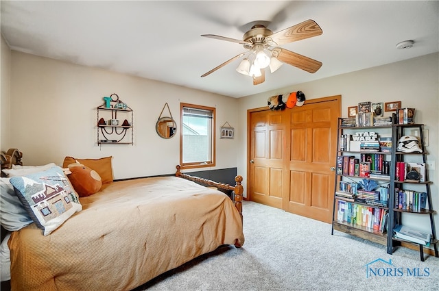 bedroom featuring carpet flooring, ceiling fan, and a closet