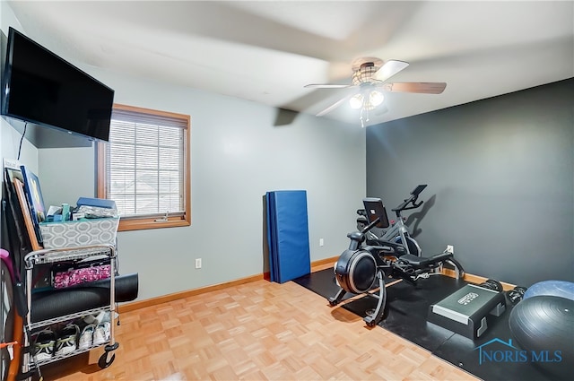 workout room featuring ceiling fan and parquet floors