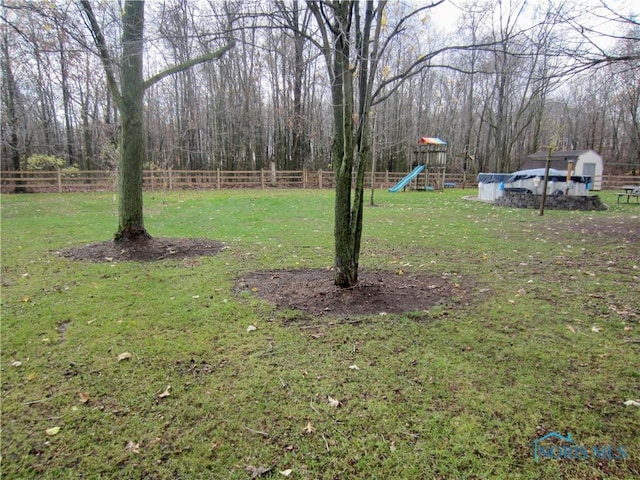 view of yard with a covered pool