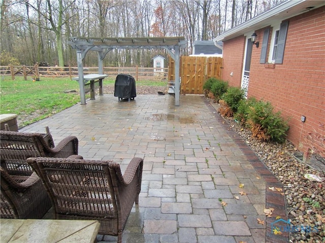 view of patio with a pergola and area for grilling