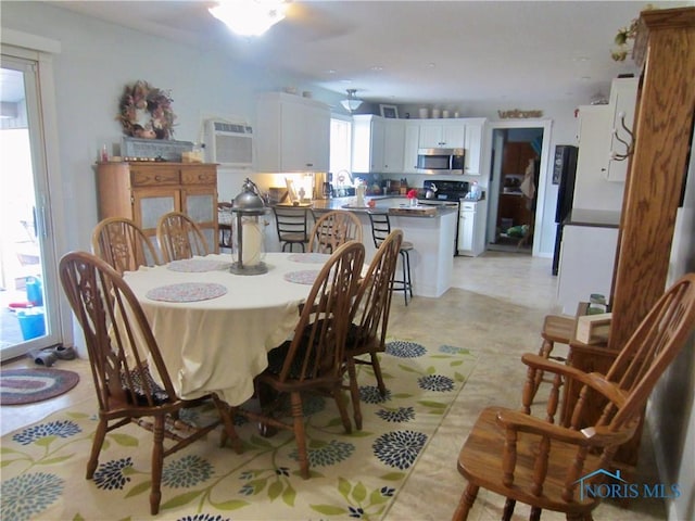 dining room with a wall mounted air conditioner