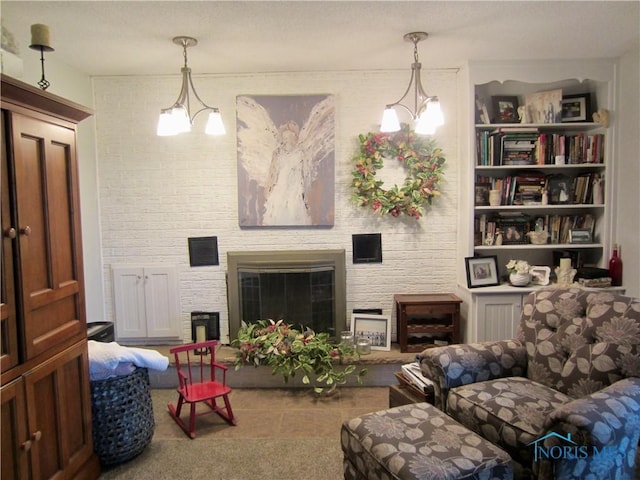 living room featuring a fireplace and a chandelier