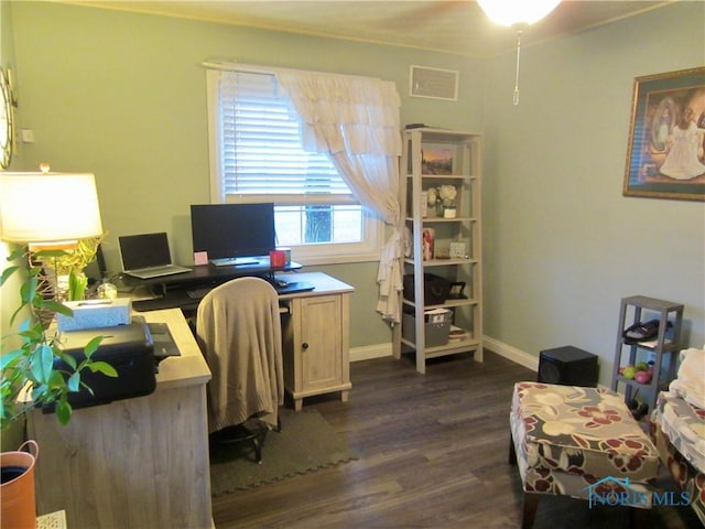 home office with dark hardwood / wood-style flooring