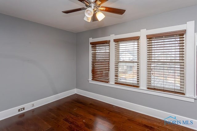 unfurnished room featuring dark hardwood / wood-style floors and ceiling fan