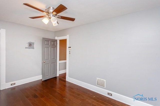 spare room featuring ceiling fan and dark hardwood / wood-style floors