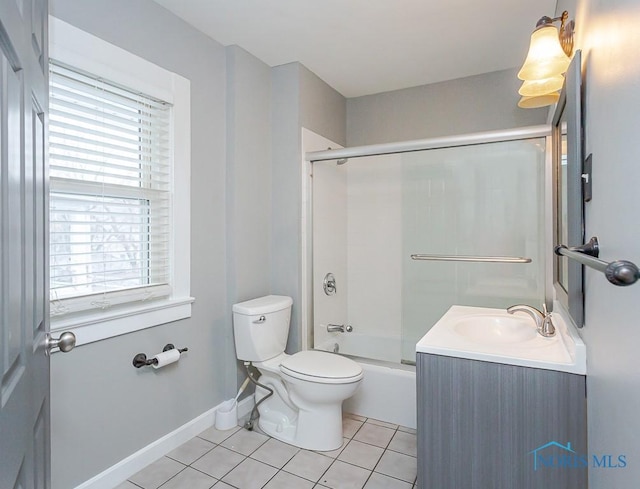 full bathroom featuring tile patterned floors, toilet, vanity, and combined bath / shower with glass door