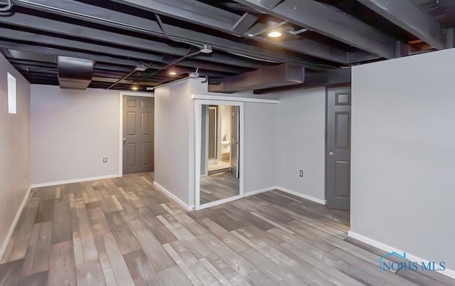 basement with hardwood / wood-style flooring