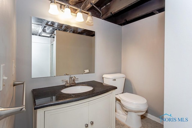 bathroom featuring tile patterned flooring, vanity, and toilet