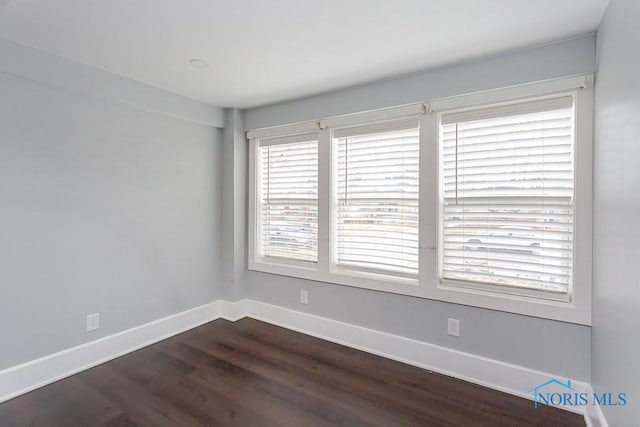 spare room featuring dark hardwood / wood-style floors