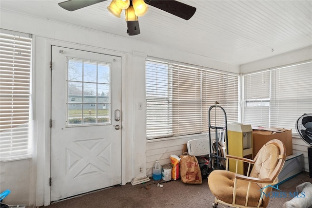 sunroom featuring ceiling fan