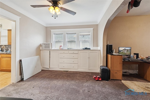 home office featuring light colored carpet, ceiling fan, and sink