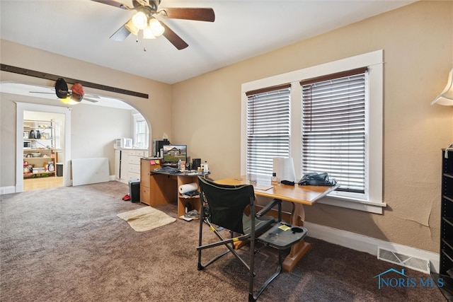 carpeted office space with ceiling fan