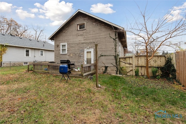 back of property featuring a yard