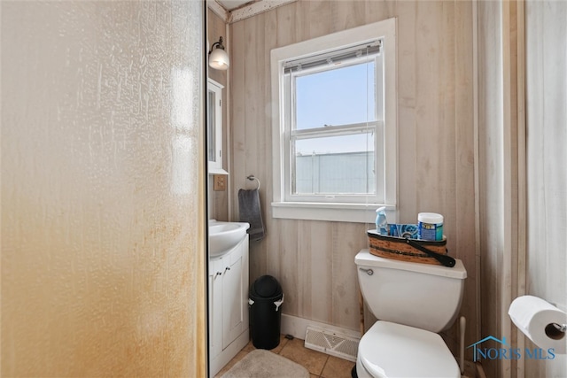 bathroom with tile patterned floors, vanity, and toilet