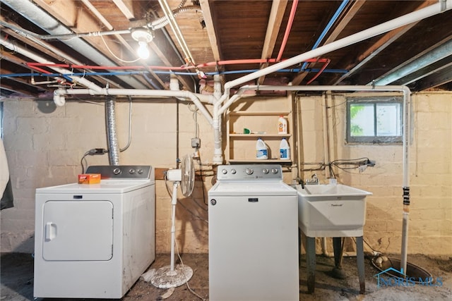 clothes washing area featuring sink and independent washer and dryer